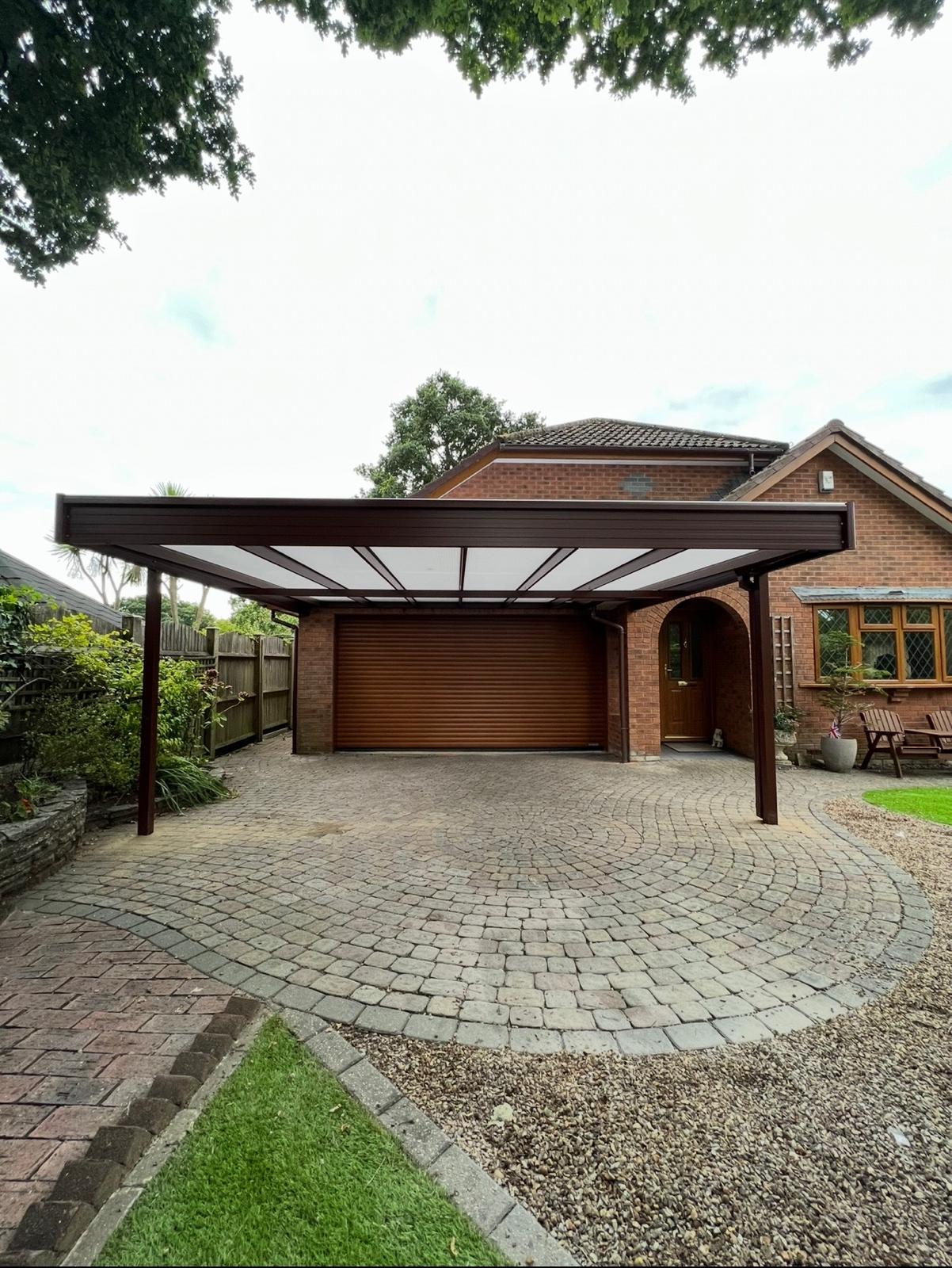 Black aluminium carport canopy installed across a residential driveway