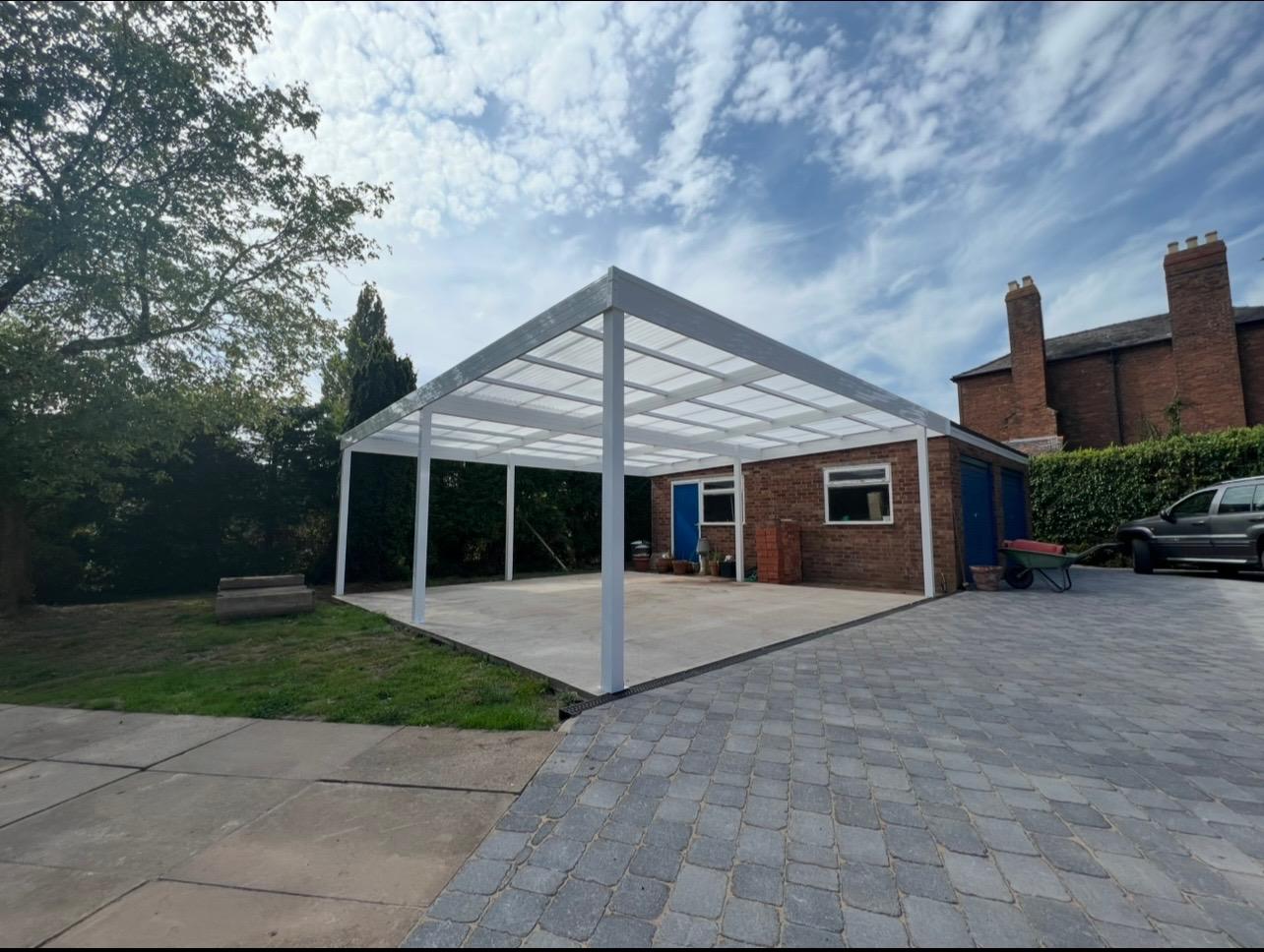 White aluminium carport canopy installed across a residential driveway