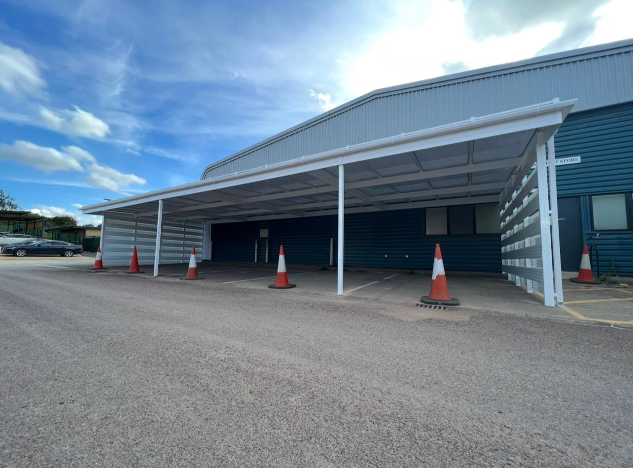 Large commercial canopy installed along an industrial building
