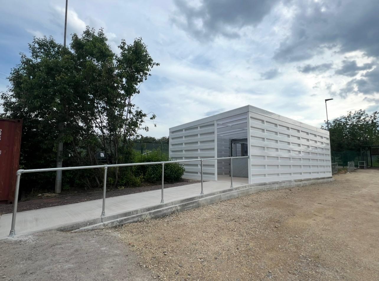 Commercial covered area with white screening and aluminium canopy