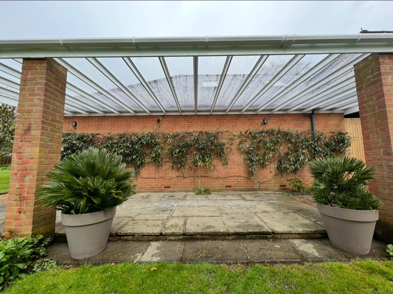 White veranda canopy over a residential courtyard garden
