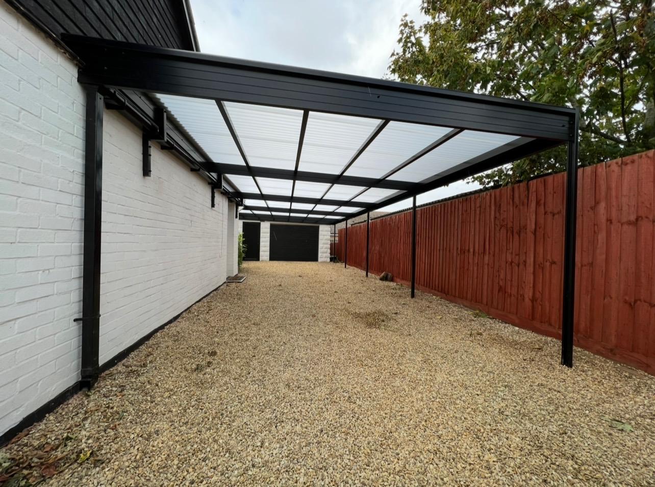 Long black aluminium side canopy beside a residential property